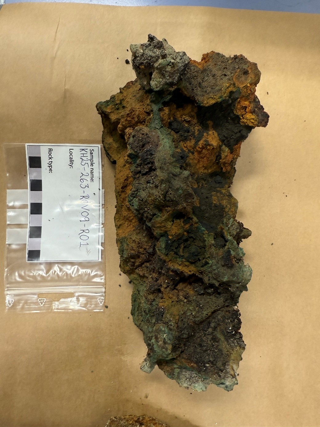 The photo shows a sulphide sample.